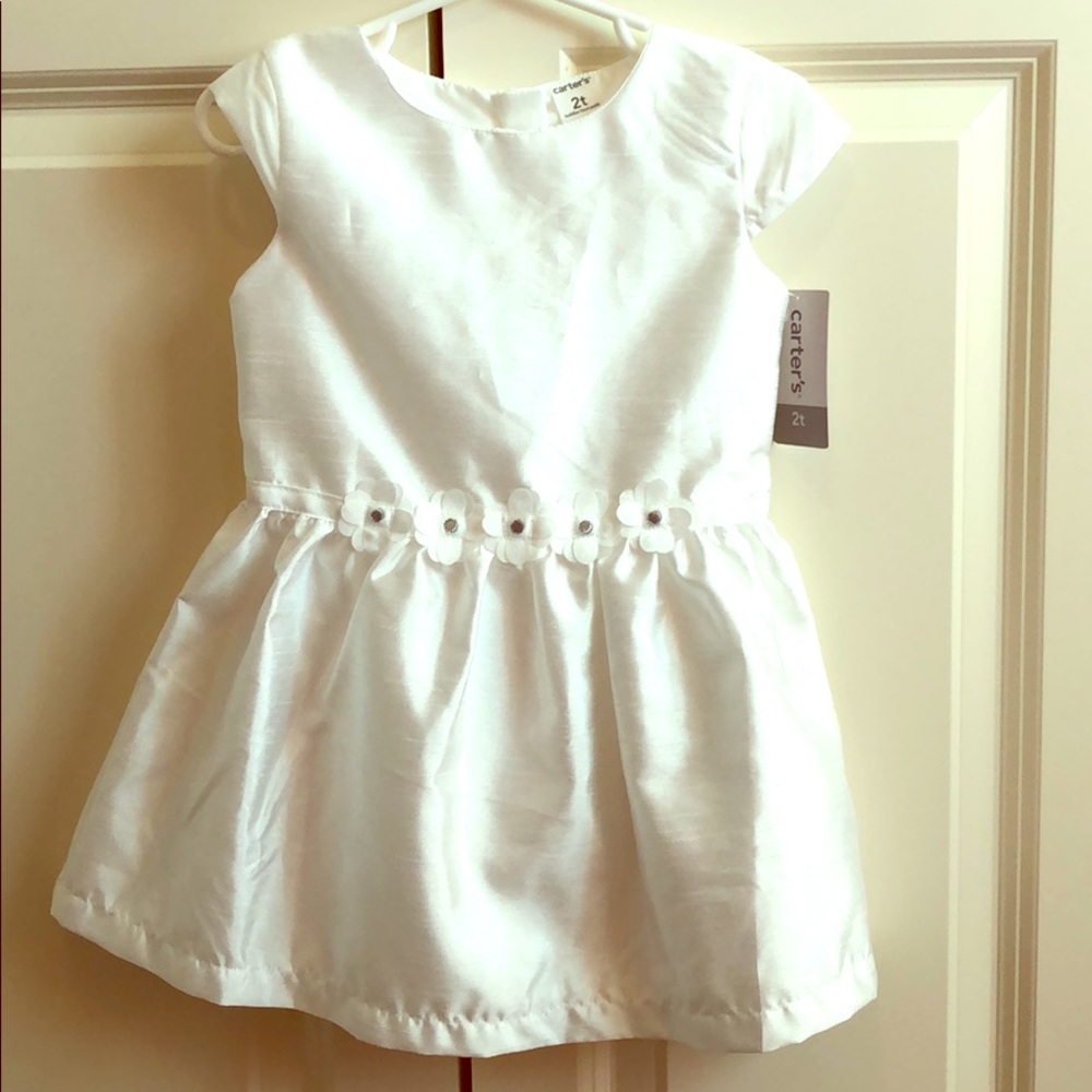 White Carter’s 2T dress with floral waist detail.